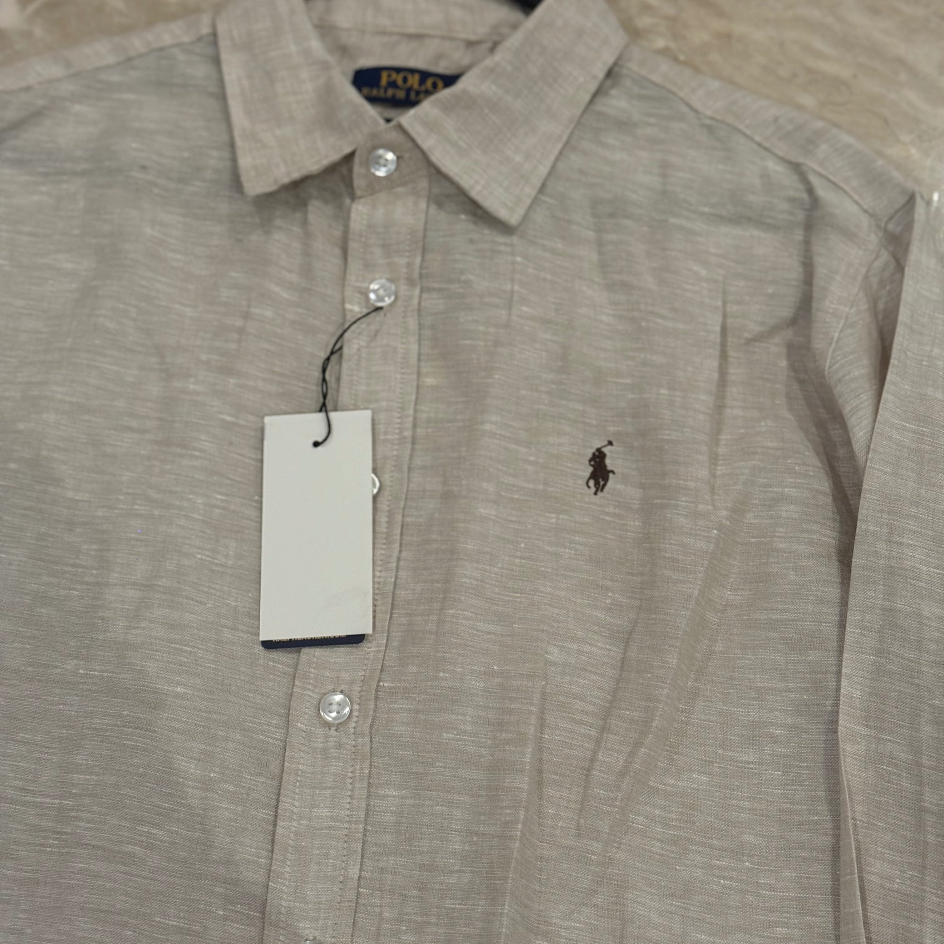 Beige shirt with Polo Ralph Lauren logo on a hanger against a beige background
