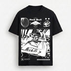 A black short-sleeve t-shirt with a large white graphic print featuring Red Bull Racing elements, including the Red Bull logo, a helmet, and a stylized race car illustration, displayed against a light gray background.