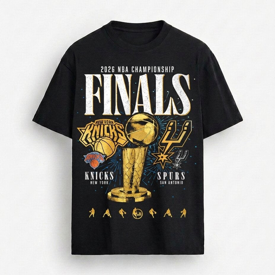 A black short-sleeve graphic T-shirt featuring a 2026 NBA Championship Finals design with the New York Knicks and San Antonio Spurs logos, a gold trophy, and white 'FINALS' text, shown on a light gray background.
